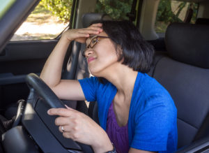Frustrated unhappy woman in her car in a traffic jam.