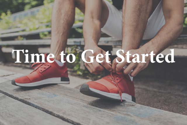 man tying shoes getting ready to start running